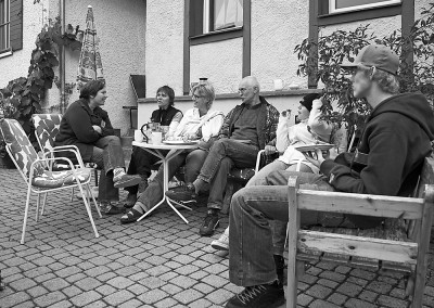 Privat mit Partnerin und Nachbarn beim Kaffeeplausch vor dem Haus